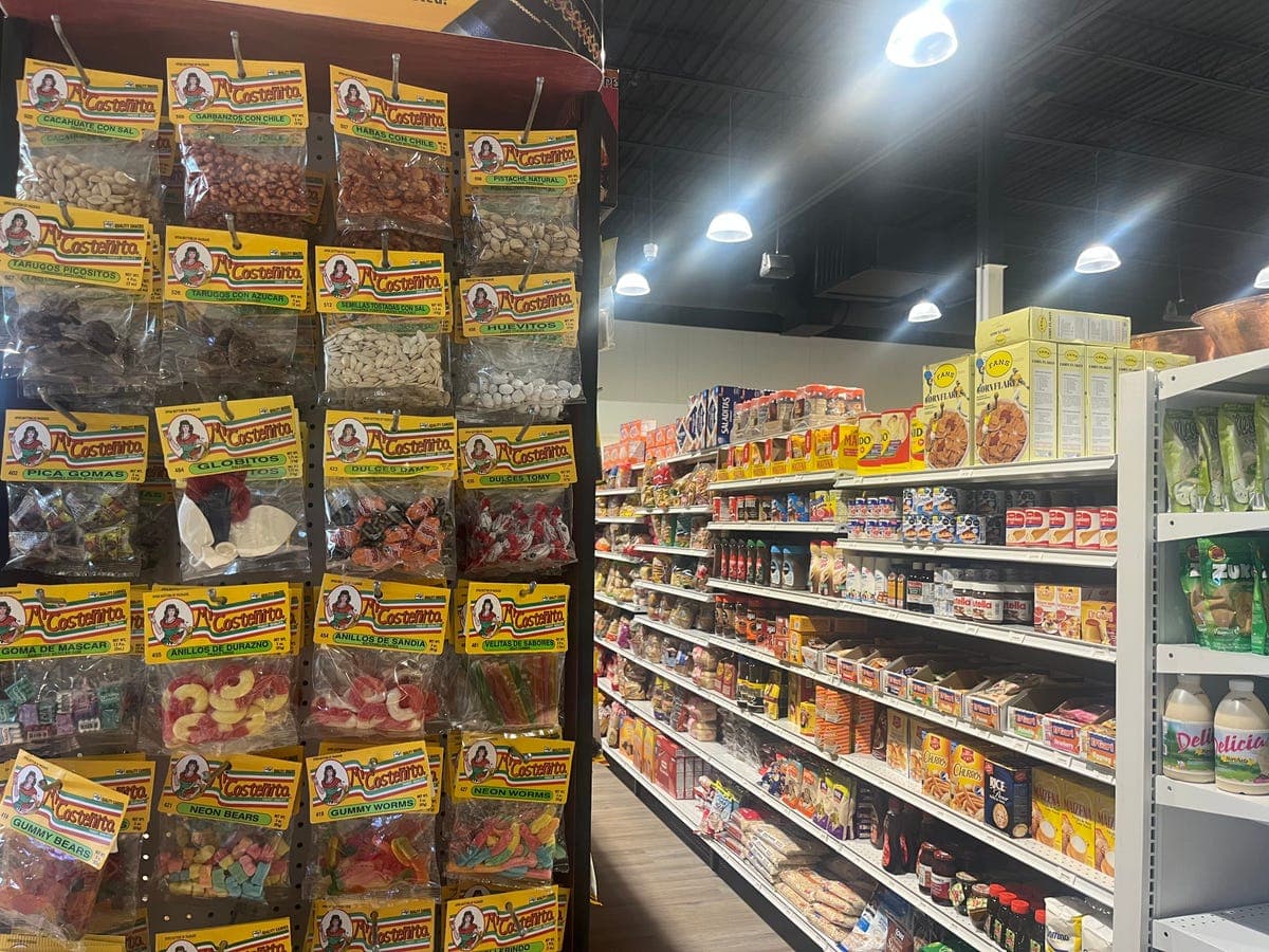 Hanging candy display with La Costeñita brand at Los Portales