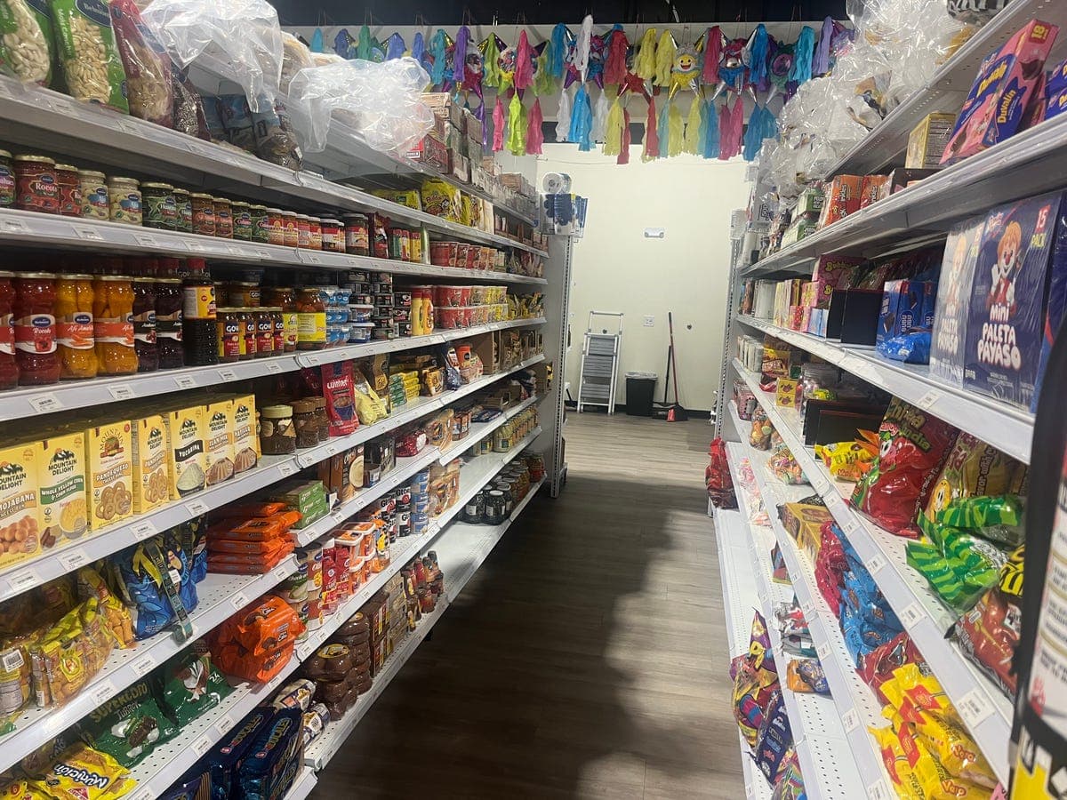 Grocery aisle with piñatas at Los Portales